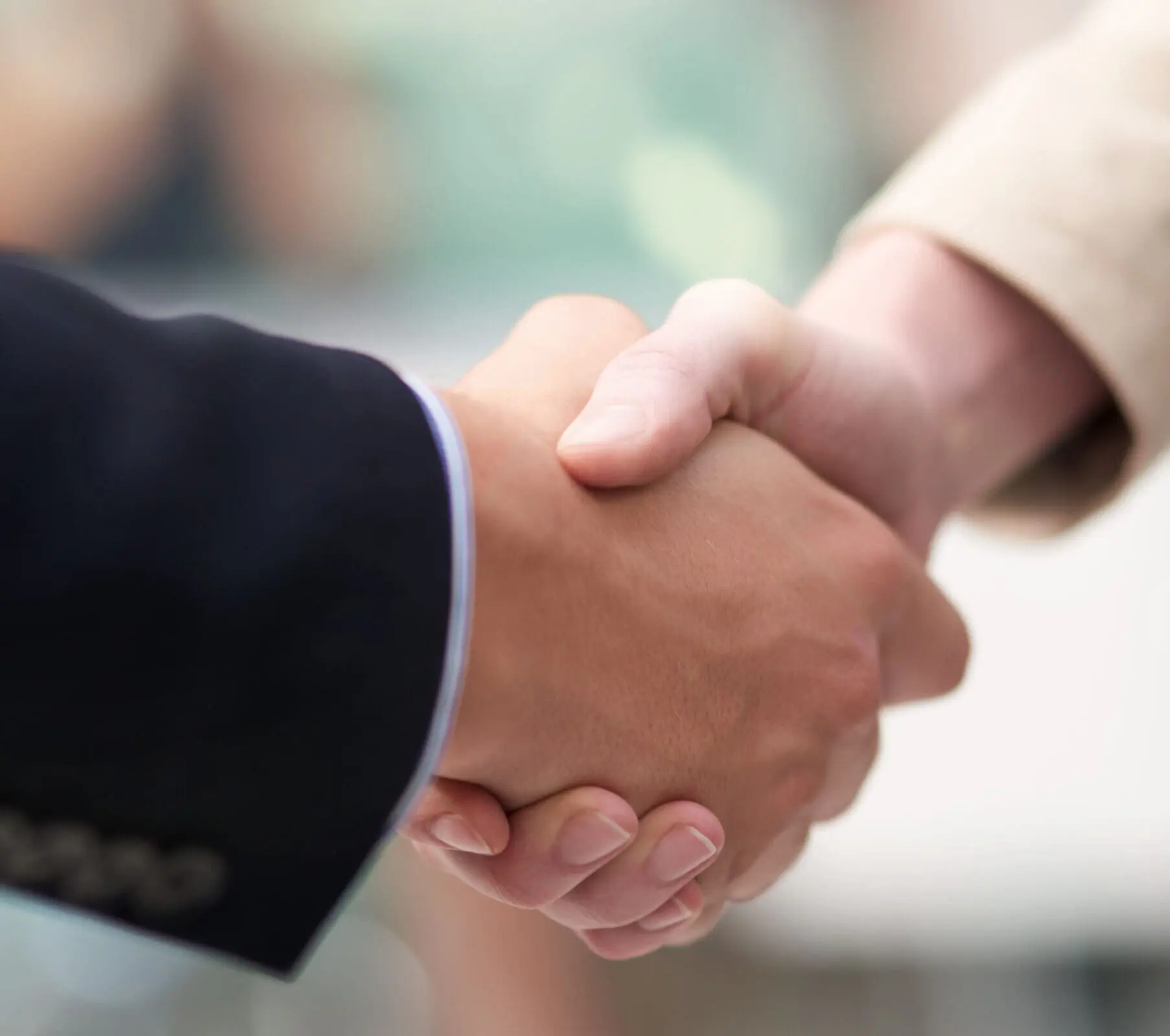 Business meetings. Shot of a coworkers shaking hands in an office